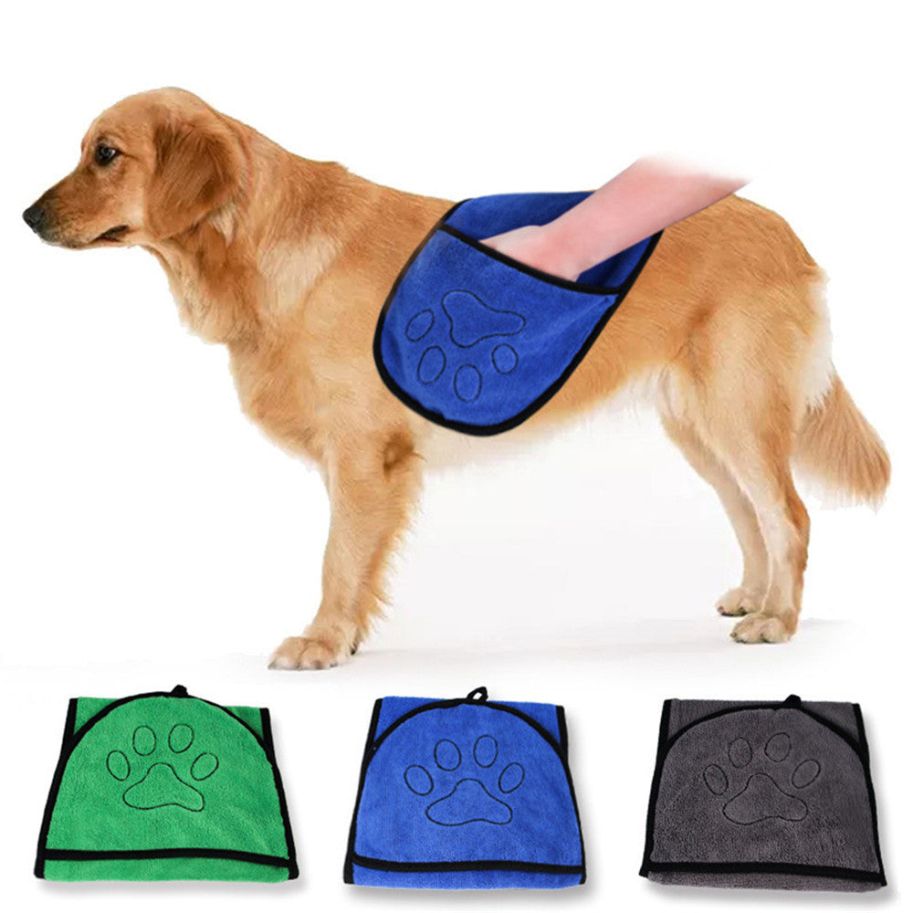 Dog wearing a blue paw print towel with three additional towels displayed below on a white background.
