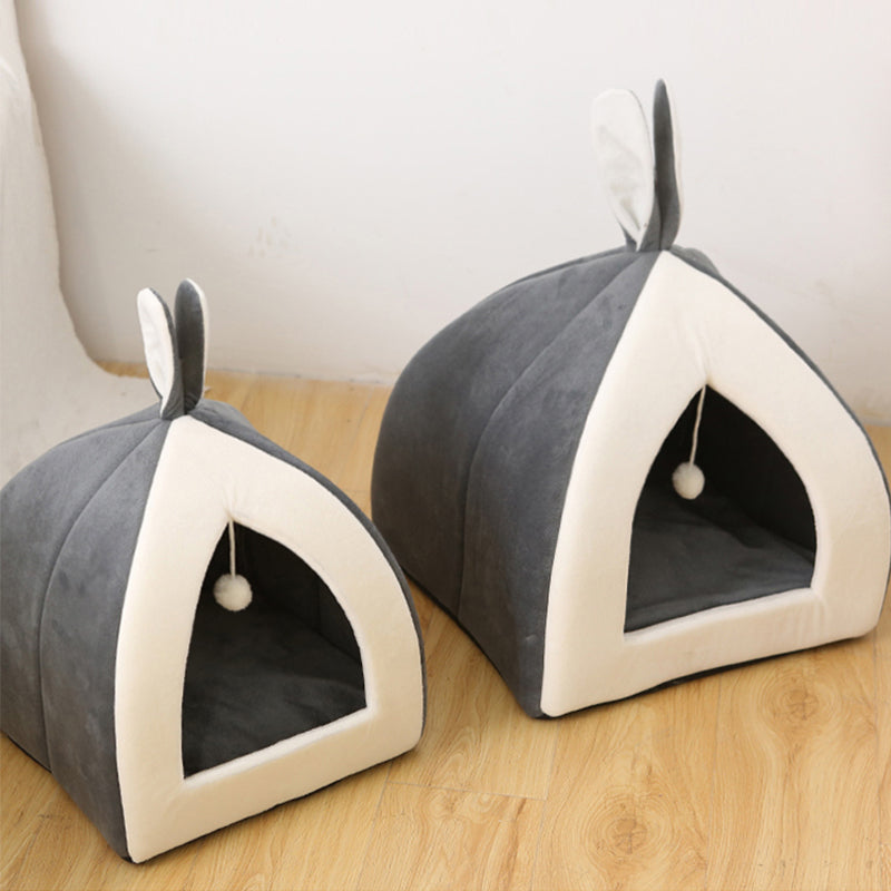 Two gray pet houses with white trim on a wooden floor.