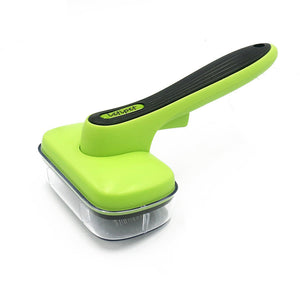 Green and black pet grooming tool on a white background