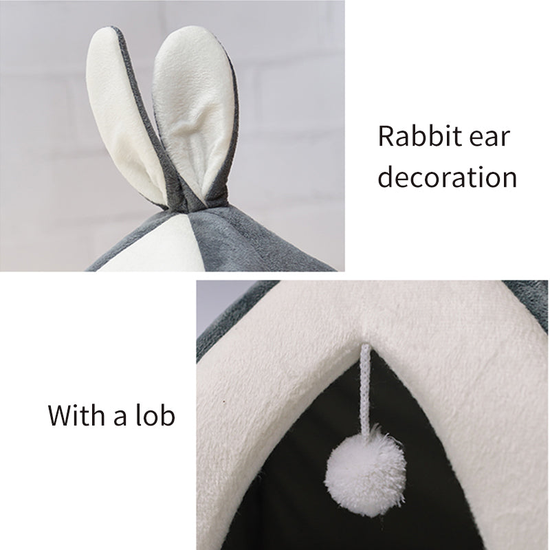 Cat house with rabbit ear decoration and a pom-pom detail on a gray background