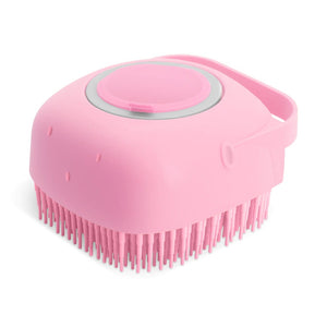 Pink silicone scrubber with bristles on a white background