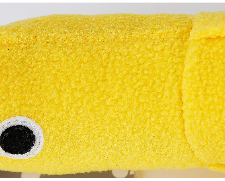 Close-up of a yellow plush shark toy with a black eye.